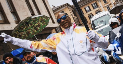 Copertina di Snoop Dog tedoforo a sorpresa: le immagini del rapper che sfila con la Fiamma Olimpica di Milano-Cortina 2026 a Gallarate – VIDEO
