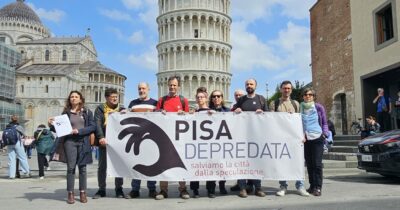 Copertina di ‘Pisa Depredata’, il report contro il piano urbanistico del Comune: “Obiettivo 100mila abitanti? Bufala per favorire la speculazione immobiliare”